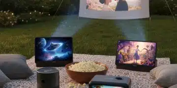 Four portable projectors showcasing their capabilities during an outdoor movie night setup.